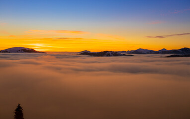 Beautiful sunset over sea of clouds. Winter landscape