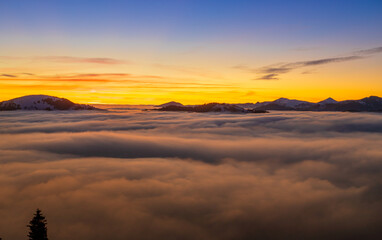 Beautiful sunset over sea of clouds. Winter landscape