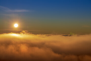 Beautiful sunset over sea of clouds. Winter landscape