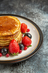 front view yummy pancakes with fruits and honey on light background breakfast sweet fruits