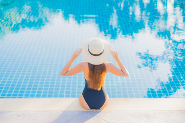 Portrait beautiful young asian woman relax smile leisure around outdoor swimming pool nearly sea beach ocean