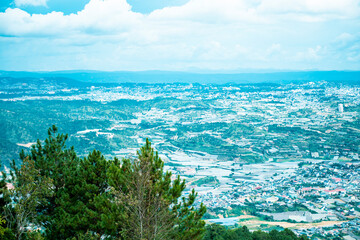Obraz premium View on Da Lat city from the peak at Langbiang mountain, Da Lat, Vietnam, Southeast Asia 