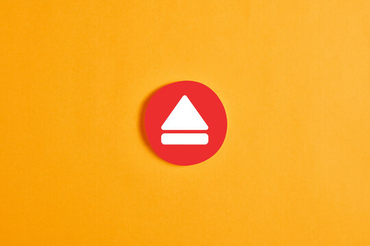 Red round circle with an eject button or icon