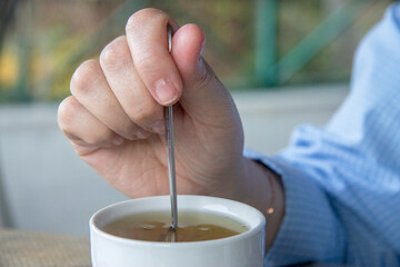 Cup of herbal tea in white cup outdoors. Tea from herbs of highlands regions