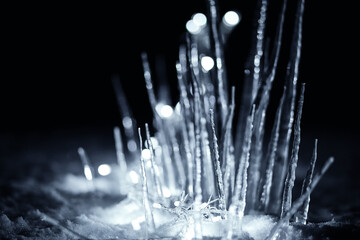 Naklejka na ściany i meble winter ice castle from icicles in snow at dark night