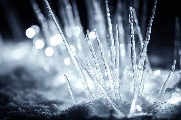 winter stalagmite icicles in snow in dark