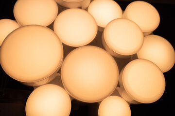 Closeup surface group of circle light bulb with warm light and dark background