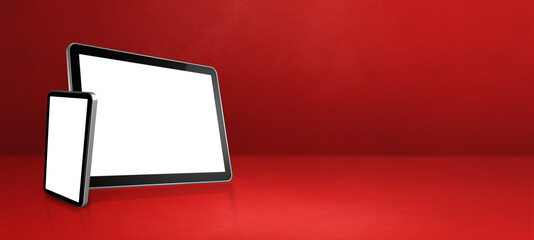 Mobile phone and digital tablet pc on red office desk. Background banner