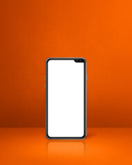 Mobile phone on orange office desk background