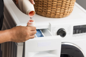 Pour some laundry detergent on the clothes and put it in the washing machine.