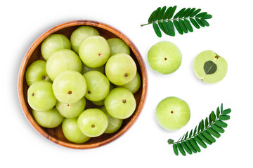 Indian gooseberry fruits ( phyllanthus emblica, amla ) in wooden bowl with green leaf and slice isolated on white background. Top view. Flat lay.