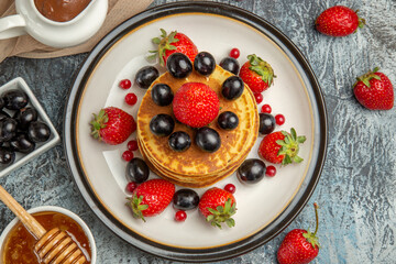 top view delicious pancakes with honey and fruits on light background sweet fruit cake