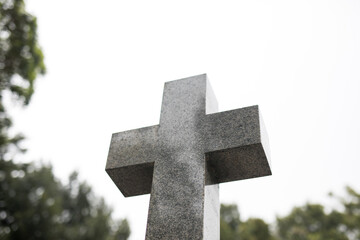 Stone cross against blank sky