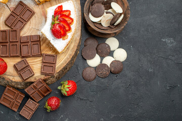 top view cake slices with chocolate bars and cookies on the dark background fruit sweet pie
