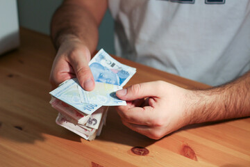 person holding money.Hands counting Turkish lira banknotes. Finance concept. 