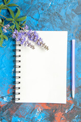 top view a notebook a pen on blue background