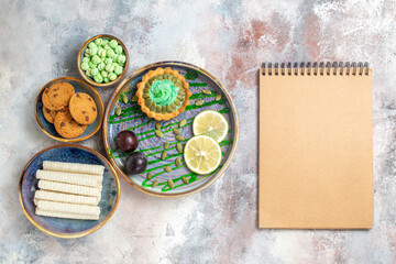 top view little cake with fruits and candies on light background sweet dessert biscuit