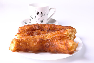 Breakfast with churros and cup of coffee with white background