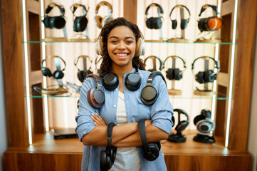 Woman with headphones in audio store, music fan