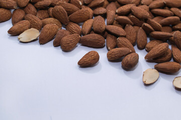 Peeled almonds on a white background.