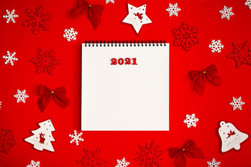 New Year 2021. Christmas greeting backgrounds. Holiday gifts and Christmas sales. The symbol of the year of the bull on a red background with elegant sparkling ornaments and snowflakes.