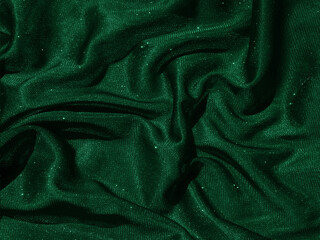 Shiny green emerald crumpled fabric texture. Elegant cloth background