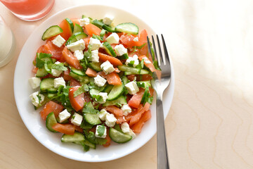 Cucumber and tomato salad with feta cheese.  Greek style salad.  Healthy and dietary food.  Weight loss program meal.