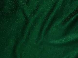 Shiny green emerald crumpled fabric texture. Elegant cloth background