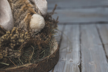   nest of flowers with a rabbit on wooden background 