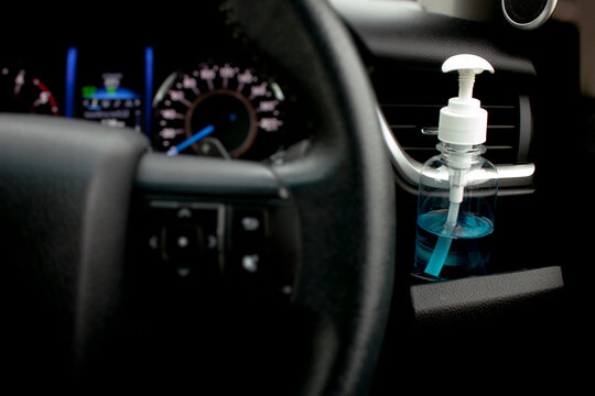 Pump Bottle Of Hand Sanitizer Placed In A Car’s Cup Holder. Kill Germs, Viruses And Bacteria While Traveling. Stop Covid-19