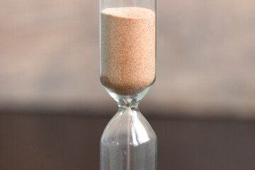 Sand pouring in an hourglass.