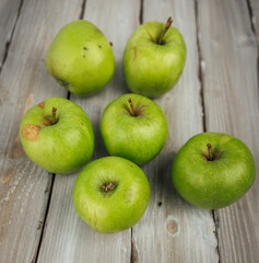 green apple on white wooden background