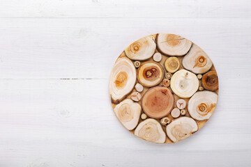 Empty round cutting board on a white wooden table.