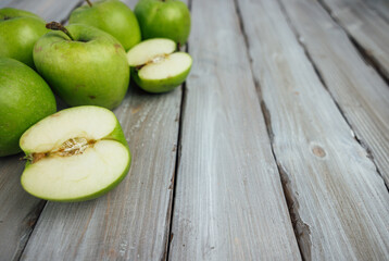 green apple on white wooden background