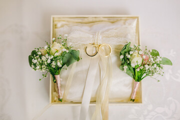 Wedding engagement rings in special box tied with creamy colored ribbons