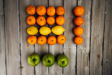 oranges and apples  on white wooden table