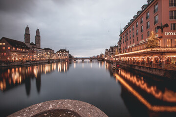 VIew of Grossmünster Church across the Limmit River in Zurich, Switzerland