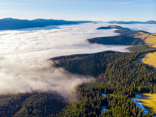 Sea of clouds and Picturesque Mountains Above. Beautiful Carpathians at early winter or Autumn Aerial View