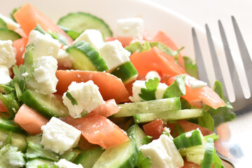 Cucumber and tomato salad with feta cheese. Greek style salad. Healthy and dietary food. Weight loss program meal.