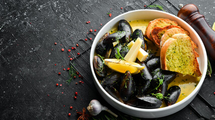 Boiled mussels with cheese sauce and garlic. Top view. Free space for text.