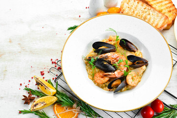 Risotto with seafood: rice, shrimp and mussels. Top view. Free space for text.