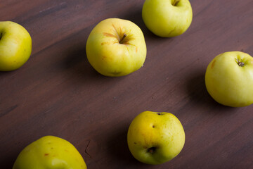 Organic apples on wooden background