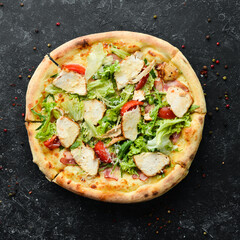 Pizza Caesar. Pizza with chicken, cheese and lettuce. Top view. Free space for your text.