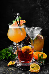 Set of colored alcoholic cocktails on a black stone background. Menu bar. Alcohol.