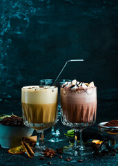 Coffee set: cocoa and hot chocolate with coffee beans. On a black background. Top view.