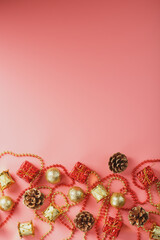 Christmas or new Year pink background with red and gold decorations for Christmas tree with free space.