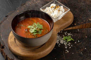 Spicy Japanese Tom Yam Soup with rice, chicken fillet, mushrooms and chili. Hot first course.