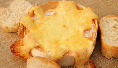 an oven-baked camembert with bread rolls