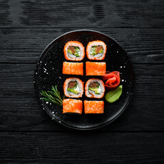 Sushi set with caviar, avocado and salmon. Asian cuisine. Top view. Free space for your text.