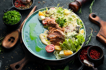 Caesar salad with chicken. Vegetable salad with chicken fillet. Top view. Rustic style.